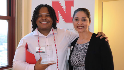 NCPA student posing with an award. 