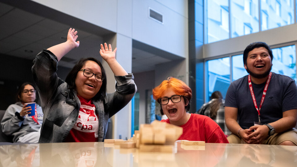 A group of students playing jenga