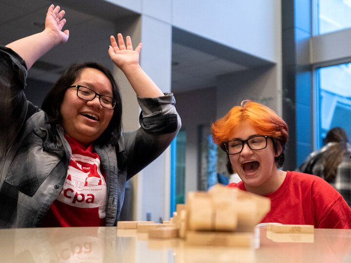A group of students playing jenga